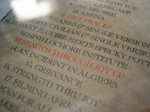 Detail of second pressing Captain Oi! rear case - showing red print and correct spelling ('Strength Through Joy')
