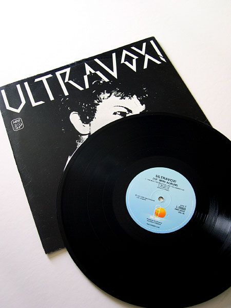Front cover and A side label of the Australian 12" mini-LP from 1981