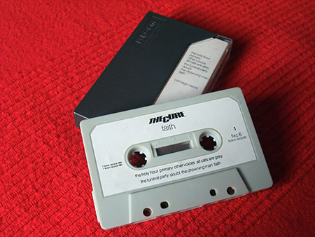 The Cure 'Faith'/'Carnage Visors' UK cassette (back and cassette)