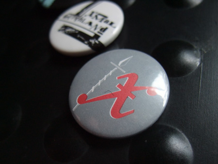 xmal-badge-0-450x338 Xmal Deutschland badge design - grey/red 'Matador' era
