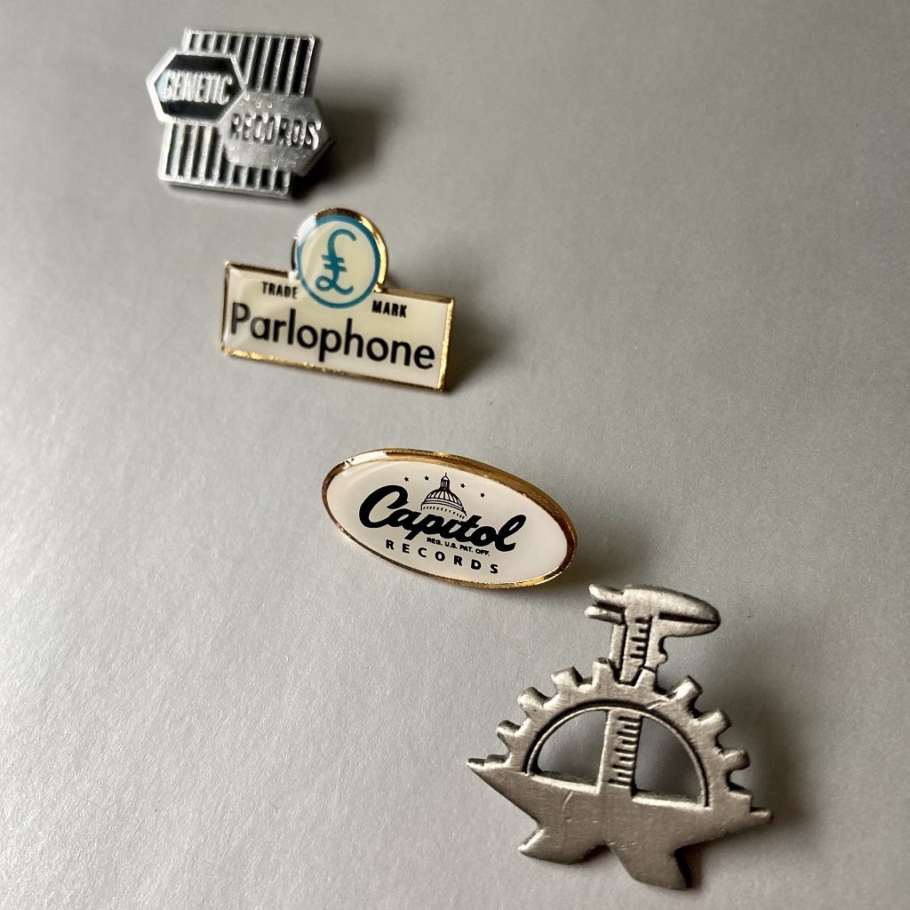 Various record company logo badges