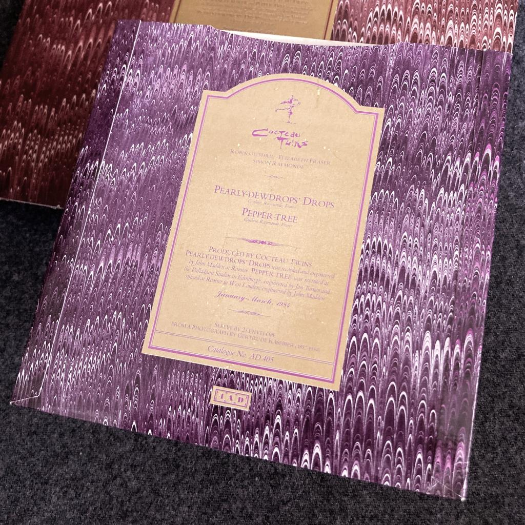 ^ Cocteau Twins Pearly Dewdrops' Drops 7" rear cover design