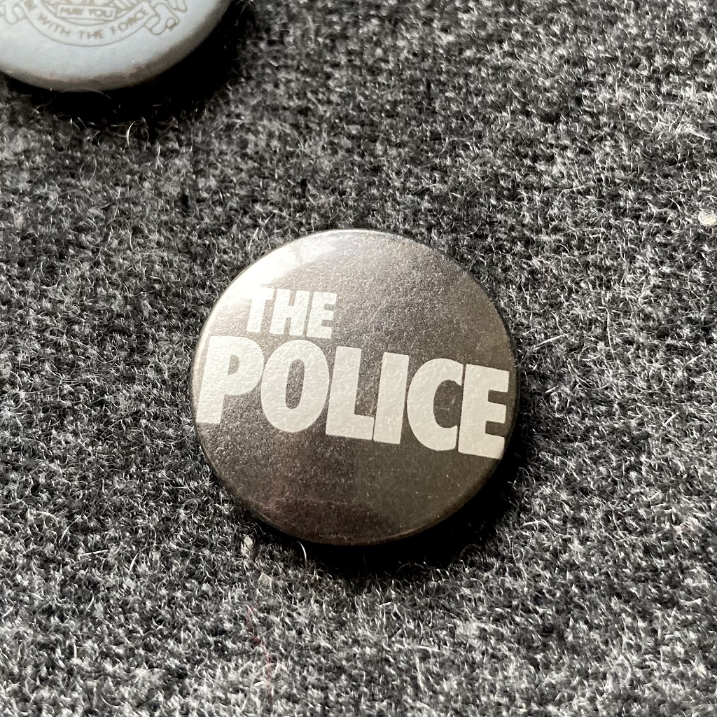 The Police logo badge black with silver print