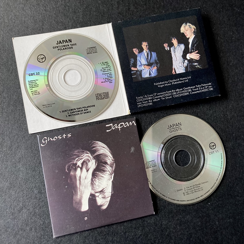 Side by side: 1988 Japan 3” CD singles - 'Gentlemen Take Polaroids' and Ghosts' disc label designs